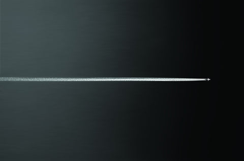 White Jet and Contrail through Gray to Black Sky